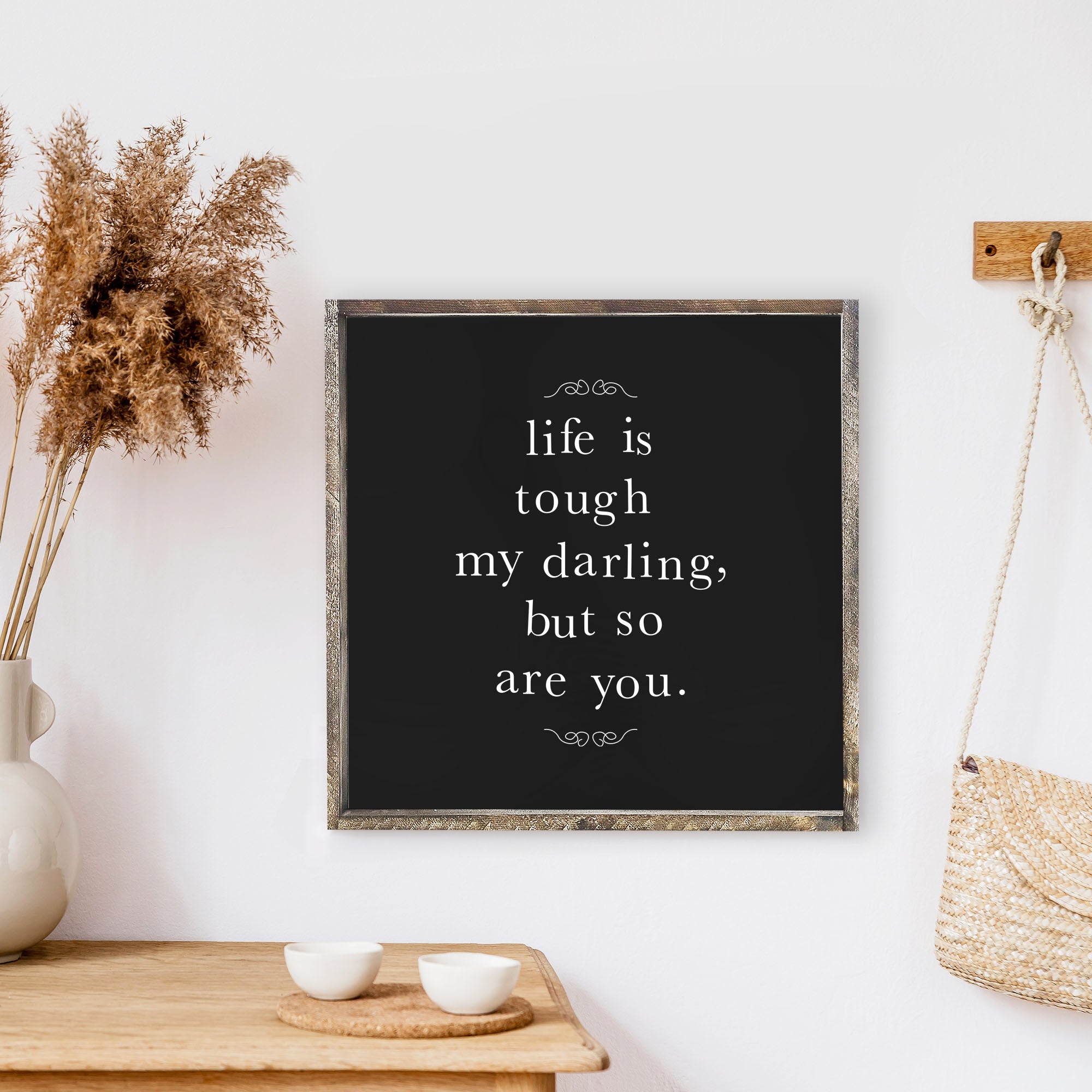 A charming 13x13 inch wood sign with the phrase 'Life Is Tough My Darling' in black text on a white background, framed in stained pine wood.