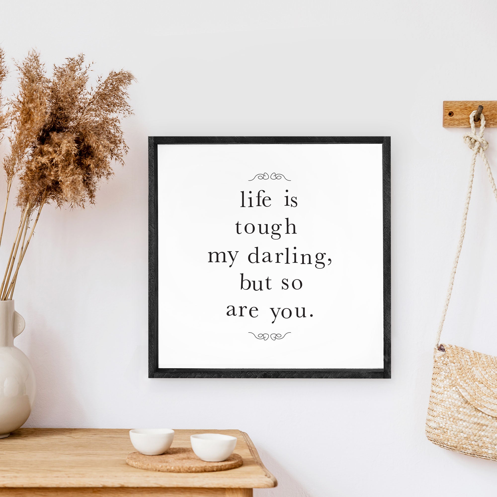 A charming 13x13 inch wood sign with the phrase 'Life Is Tough My Darling' in black text on a white background, framed in stained pine wood.