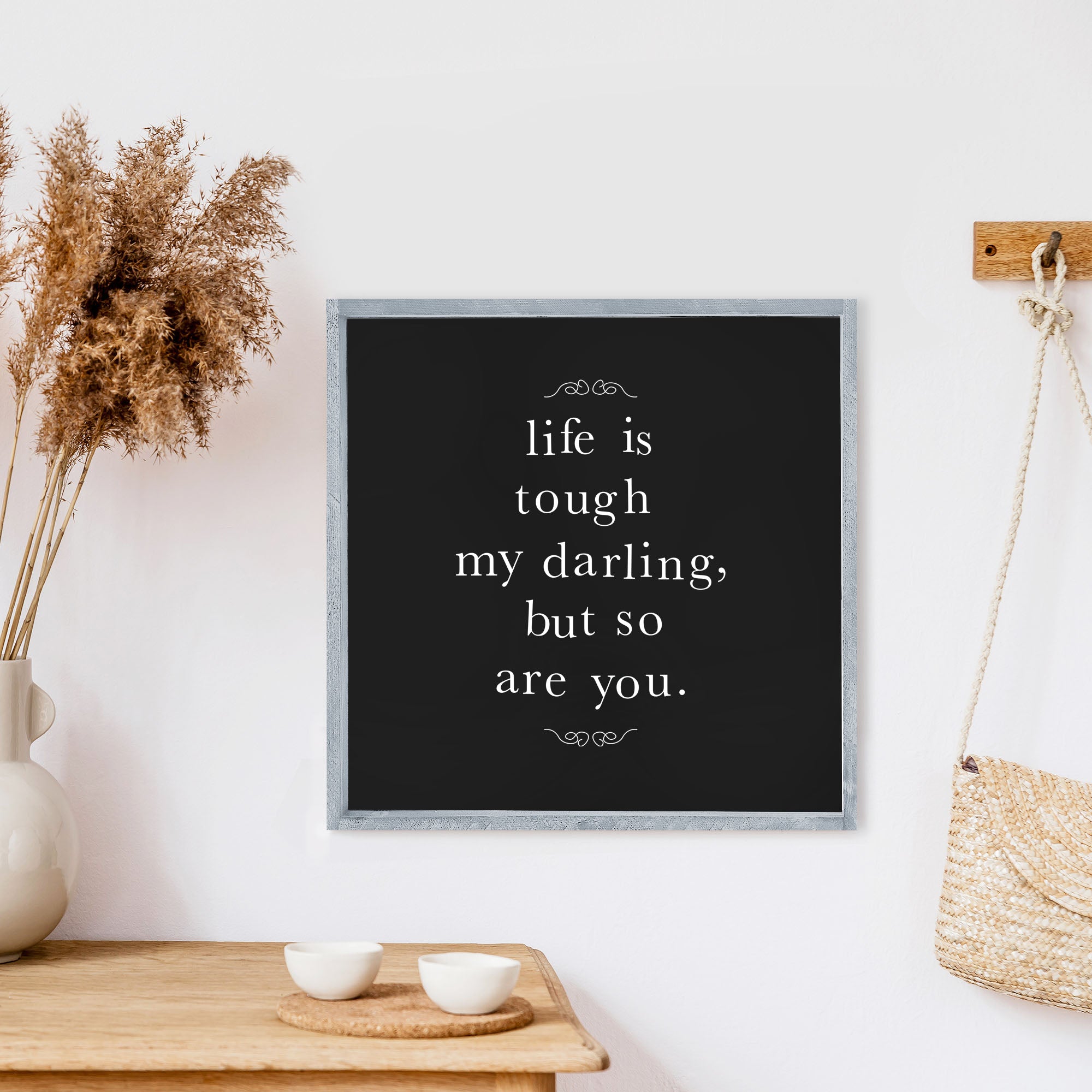 A charming 13x13 inch wood sign with the phrase 'Life Is Tough My Darling' in black text on a white background, framed in stained pine wood.