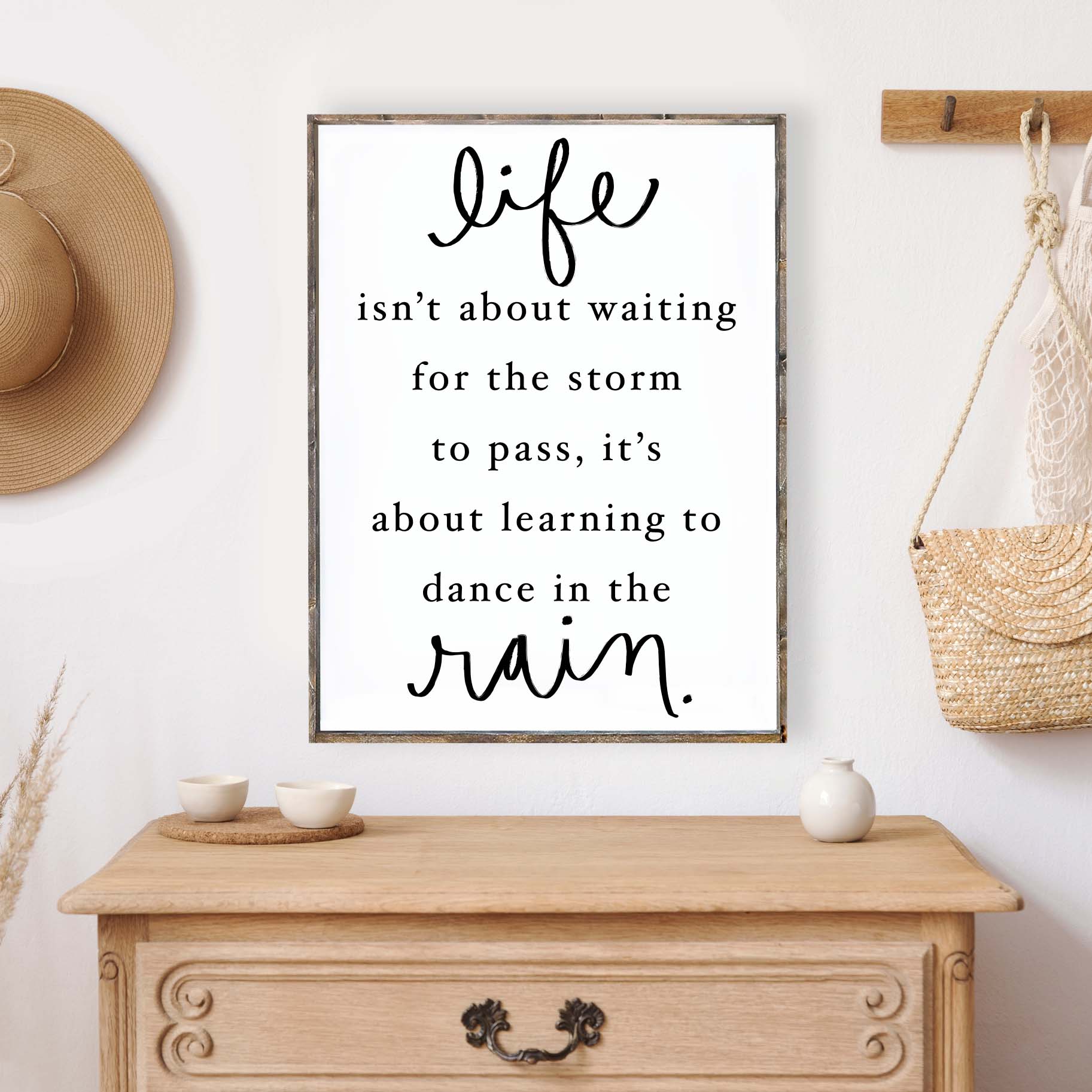 A beautifully crafted wood sign featuring the quote 'Life Isn't About Waiting For The Storm To Pass', with a rustic pine wood frame and a white background.