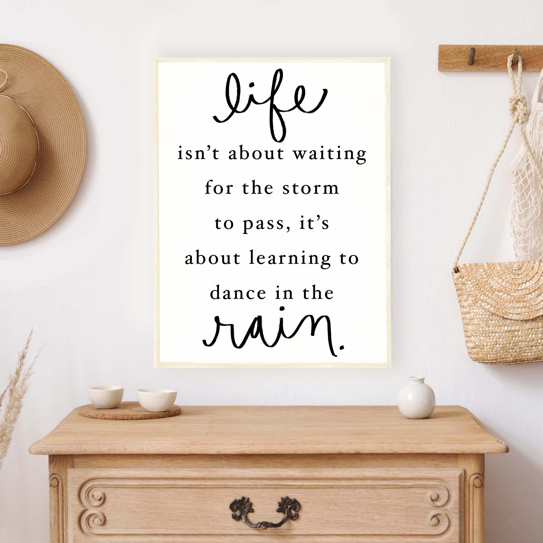 A beautifully crafted wood sign featuring the quote 'Life Isn't About Waiting For The Storm To Pass', with a rustic pine wood frame and a white background.