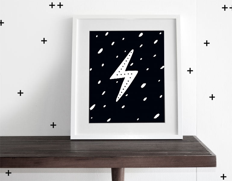 A stylish Lightning Bolt Wall Art print featuring a modern design, framed with a white matte, perfect for nursery decor.
