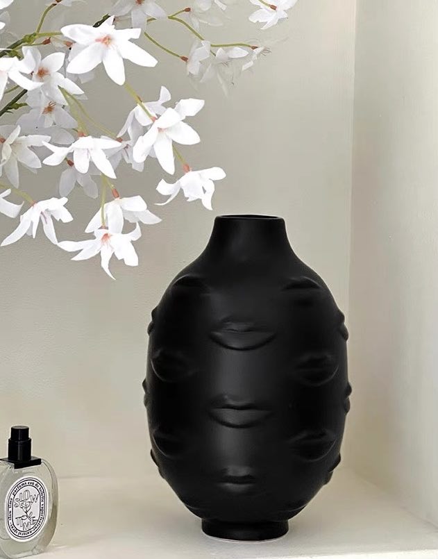 A modern abstract ceramic flower vase with moody mouth designs, showcasing a unique artistic flair for home decor.