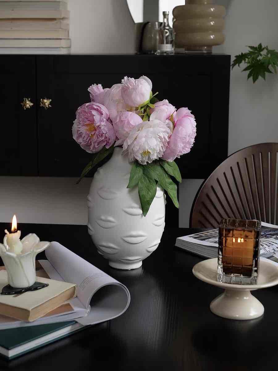 A modern abstract ceramic flower vase with moody mouth designs, showcasing a unique artistic flair for home decor.