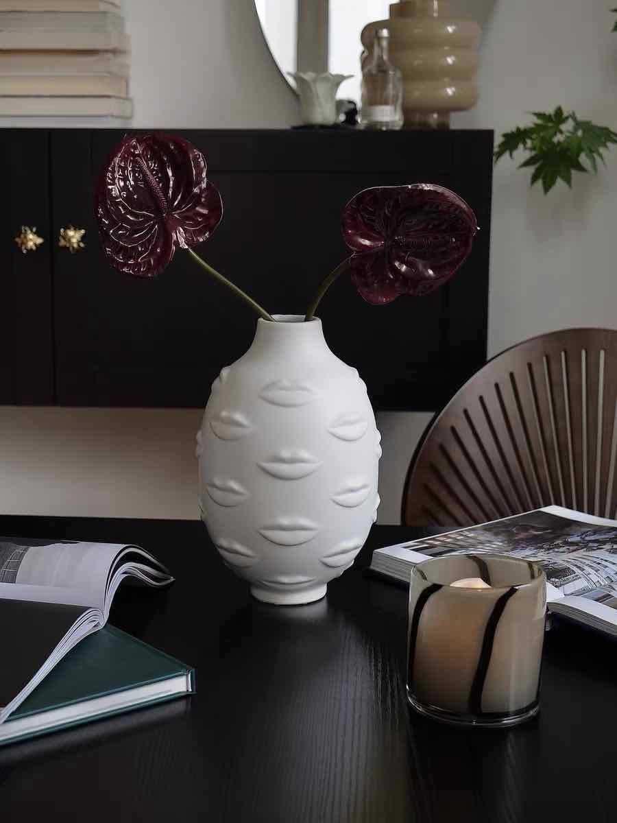 A modern abstract ceramic flower vase with moody mouth designs, showcasing a unique artistic flair for home decor.