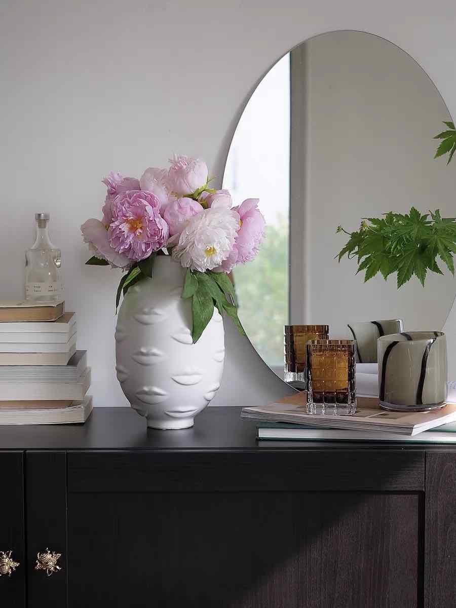 A modern abstract ceramic flower vase with moody mouth designs, showcasing a unique artistic flair for home decor.