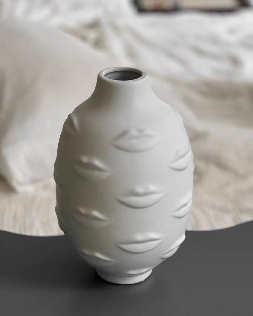 A modern abstract ceramic flower vase with moody mouth designs, showcasing a unique artistic flair for home decor.