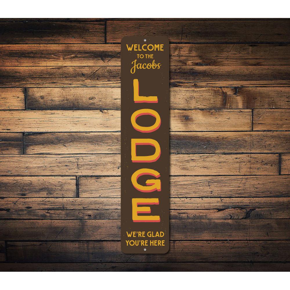 Lodge Welcome Vertical Sign made of aluminum, featuring customizable text and pre-drilled holes for easy mounting, perfect for ski enthusiasts.