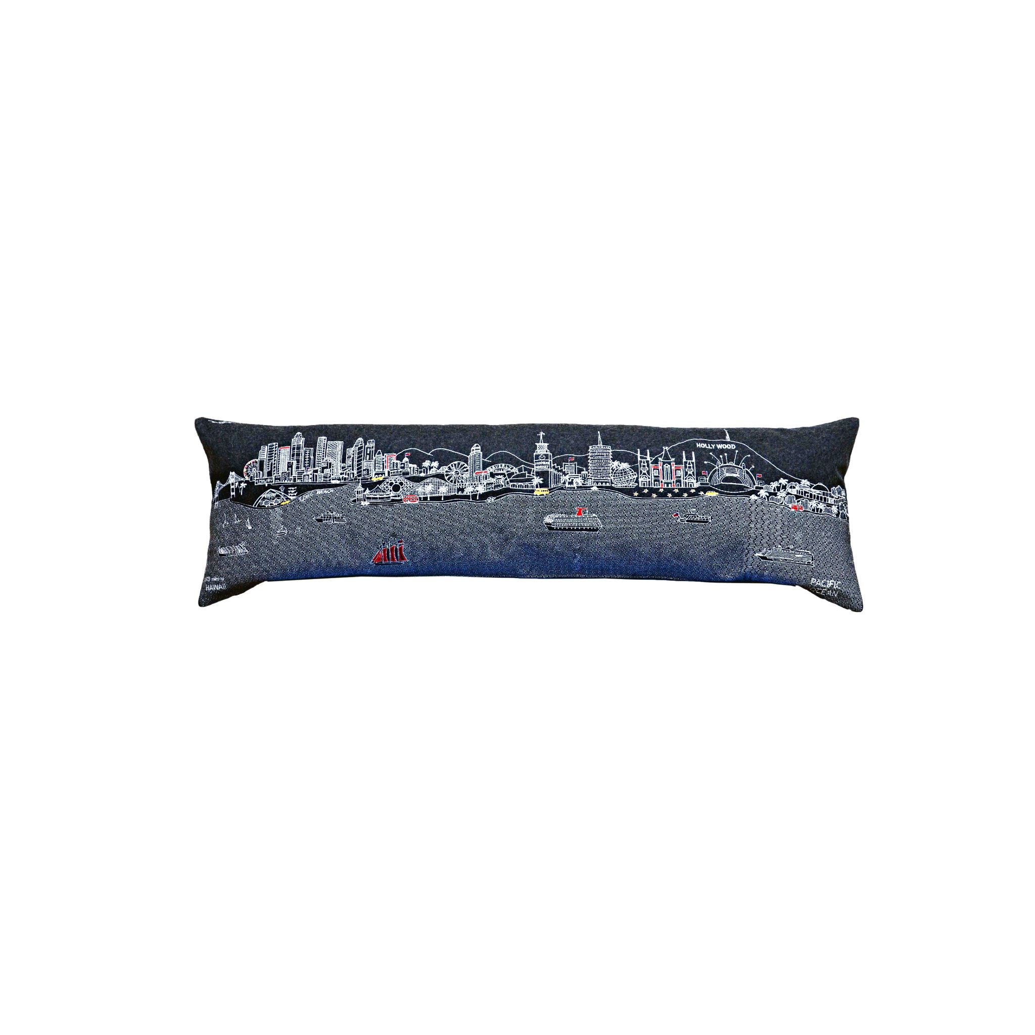 Los Angeles Pillow featuring embroidered landmarks like the Hollywood Sign and Griffith Observatory, with a red zipper at the bottom.