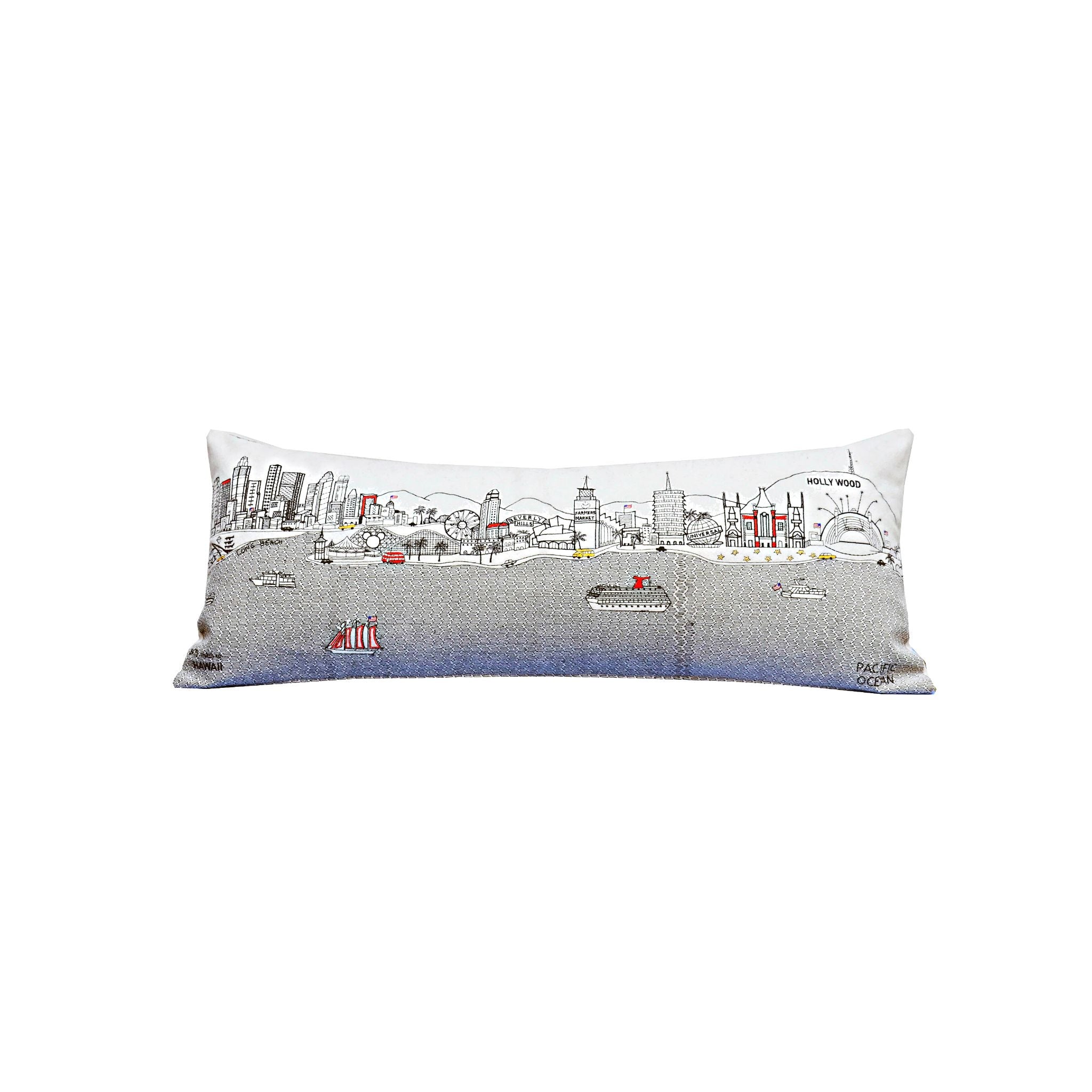 Los Angeles Pillow featuring embroidered landmarks like the Hollywood Sign and Griffith Observatory, with a red zipper at the bottom.