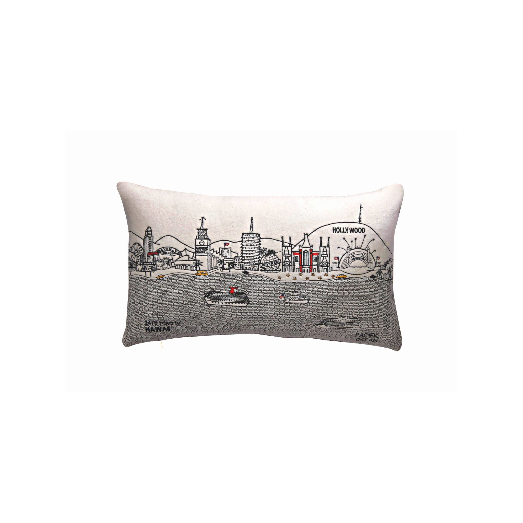 Los Angeles Pillow featuring embroidered landmarks like the Hollywood Sign and Griffith Observatory, with a red zipper at the bottom.