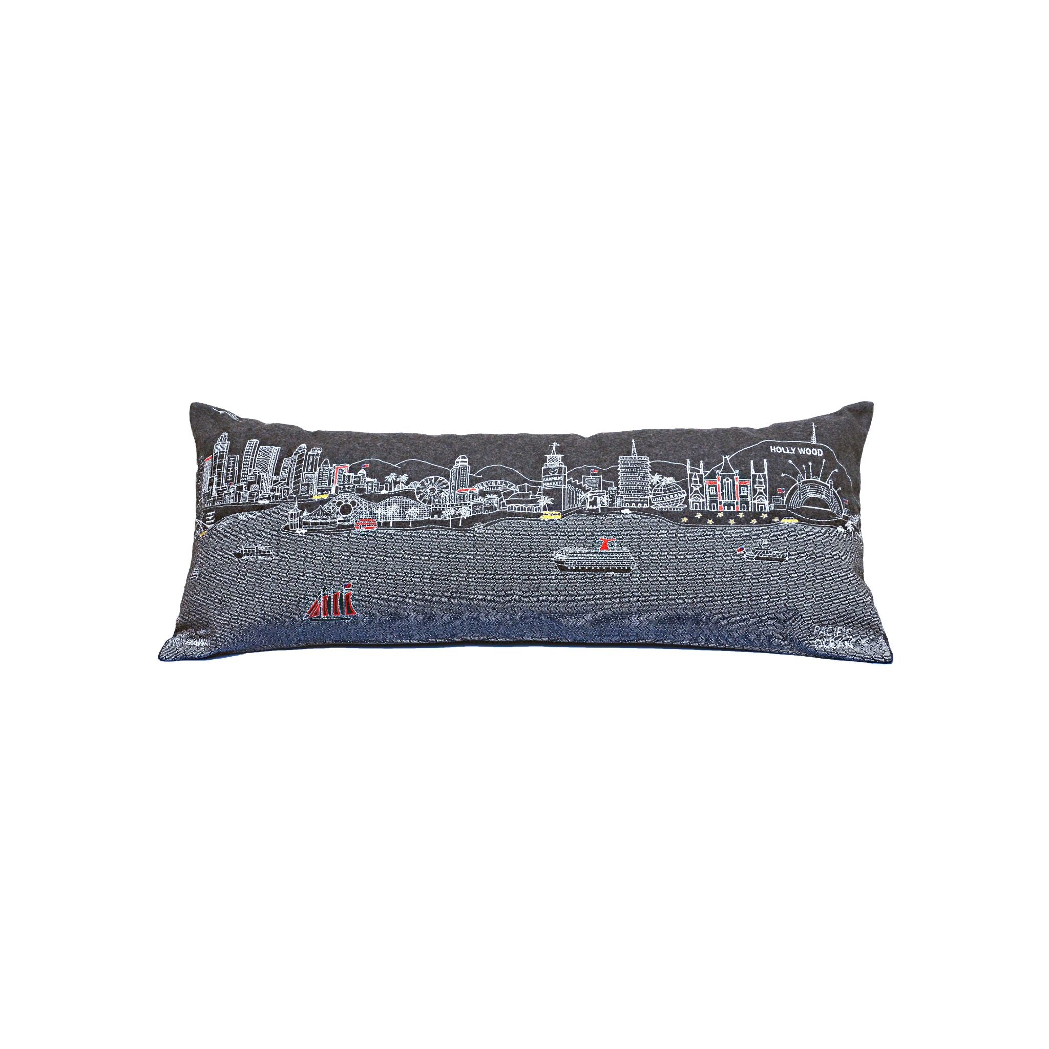 Los Angeles Pillow featuring embroidered landmarks like the Hollywood Sign and Griffith Observatory, with a red zipper at the bottom.