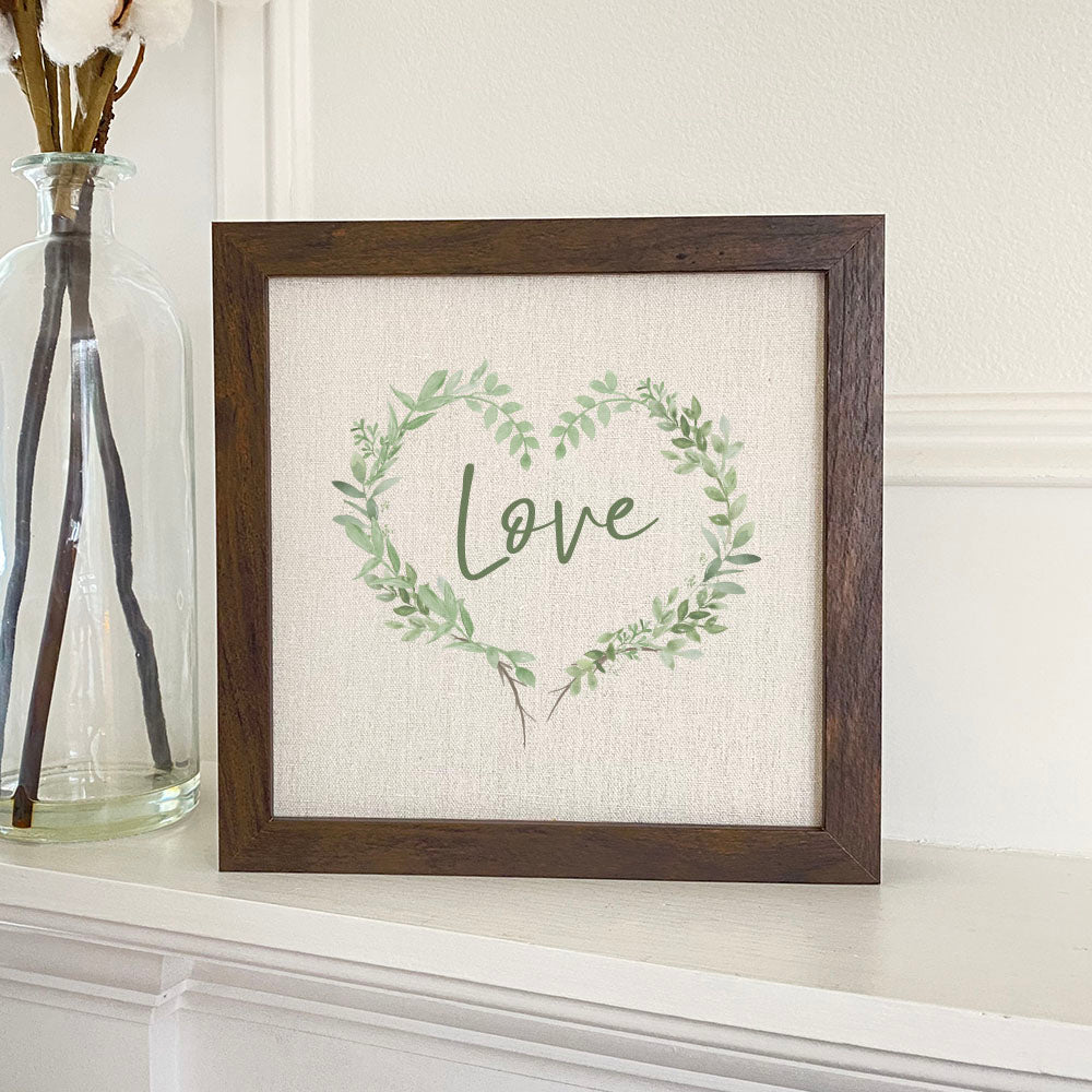 Love Greenery Heart Wreath framed sign with a wood frame and linen-look background, showcasing eco-friendly ink printing.