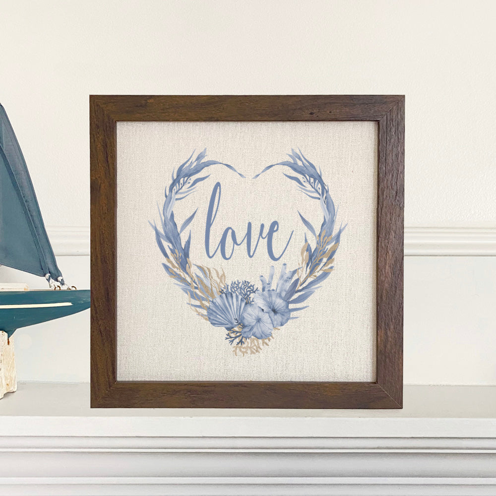 Love Ocean Wreath framed sign with a stylized wood frame and eco-friendly printing on a linen-look background.