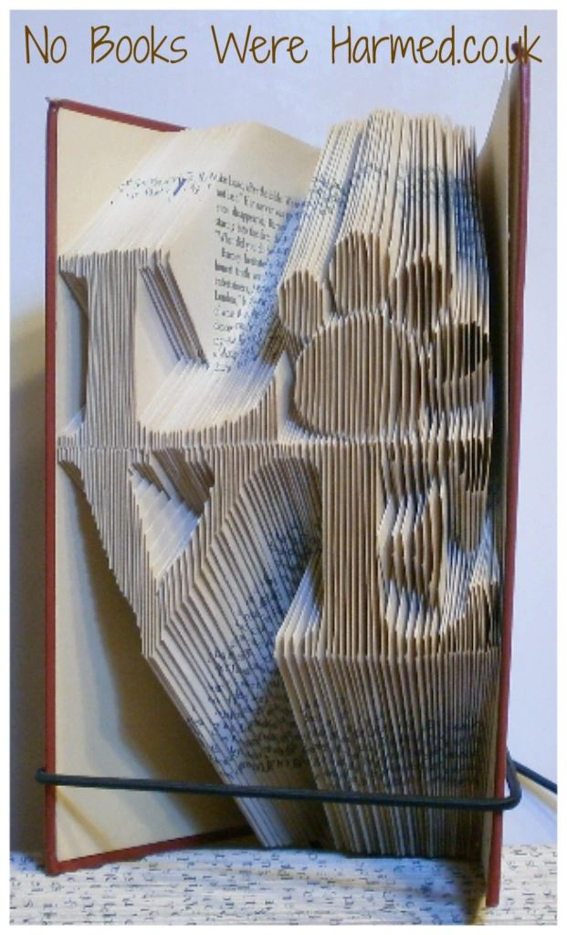 Handcrafted 'Love' square art piece featuring a paw print 'o', made from vintage book pages.