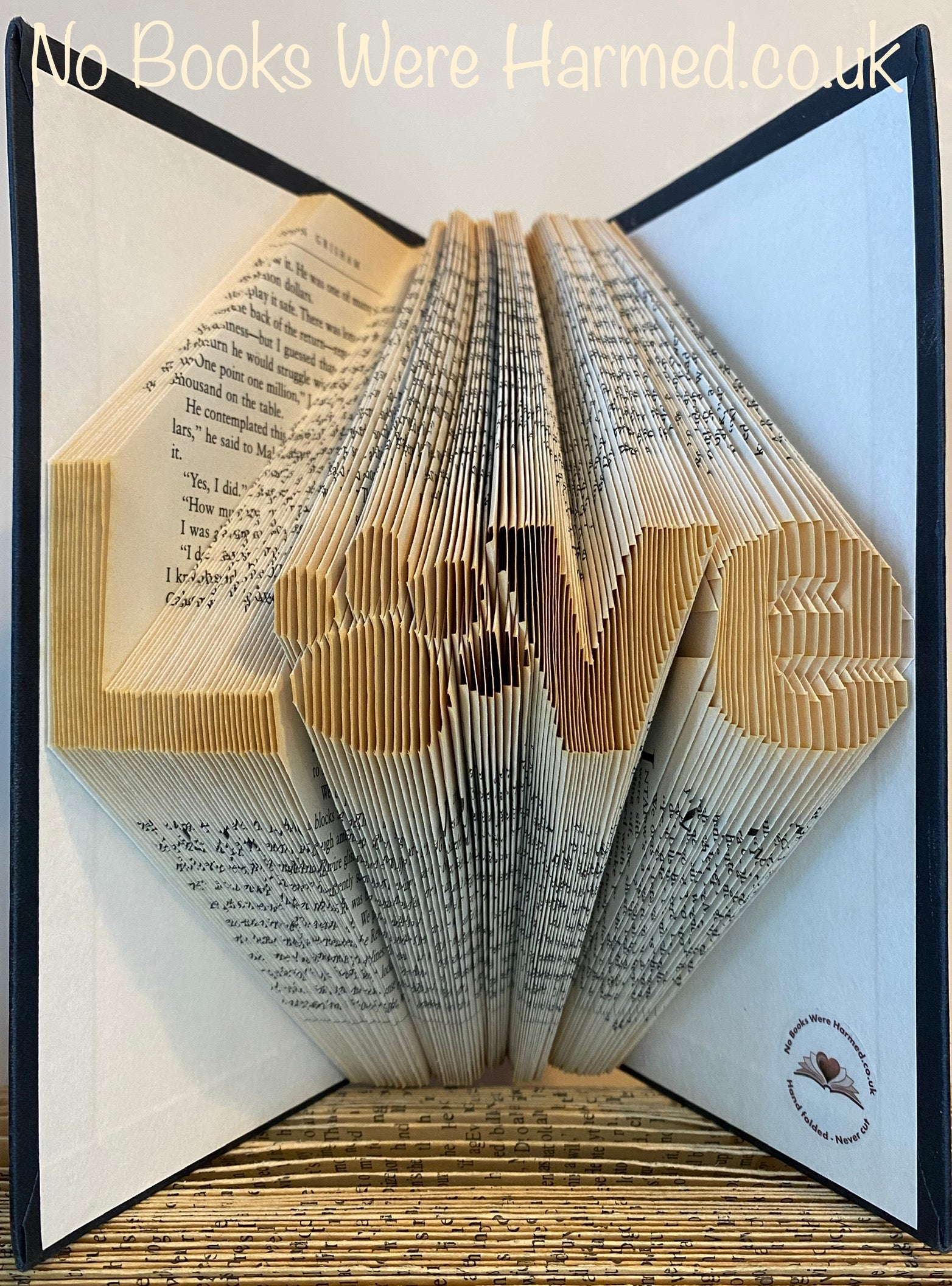 Unique 'Love' art piece featuring a dog or cat paw print, handcrafted from vintage book pages.
