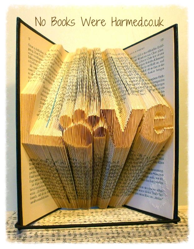 Unique 'Love' art piece featuring a dog or cat paw print, handcrafted from vintage book pages.