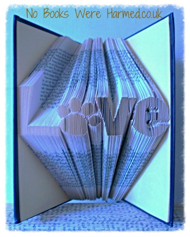 Unique 'Love' art piece featuring a dog or cat paw print, handcrafted from vintage book pages.