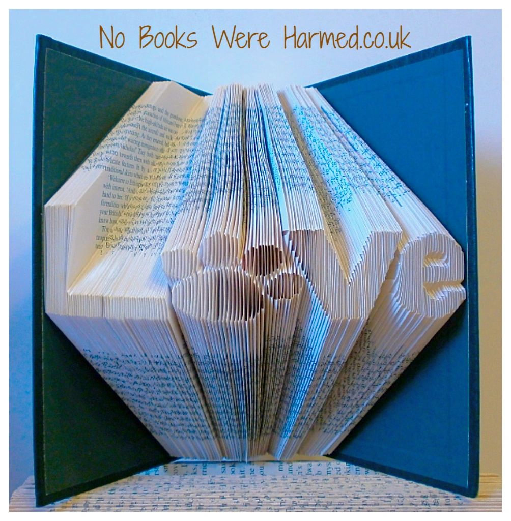 Unique 'Love' art piece featuring a dog or cat paw print, handcrafted from vintage book pages.