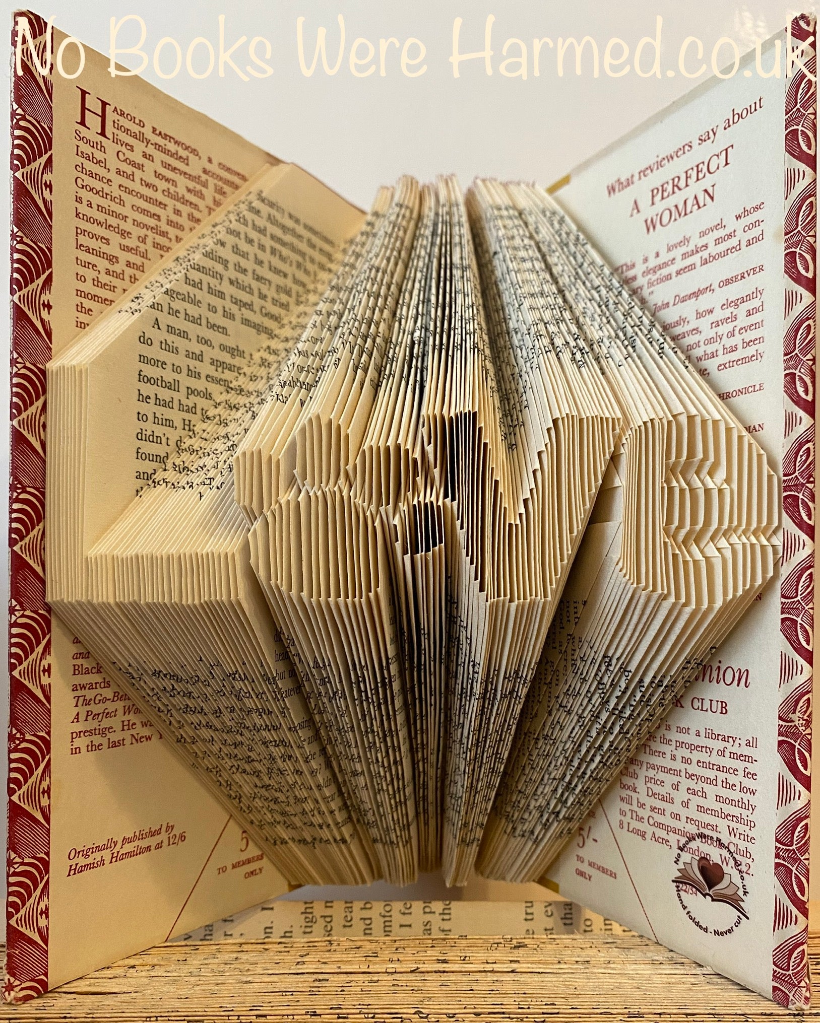 Unique 'Love' art piece featuring a dog or cat paw print, handcrafted from vintage book pages.