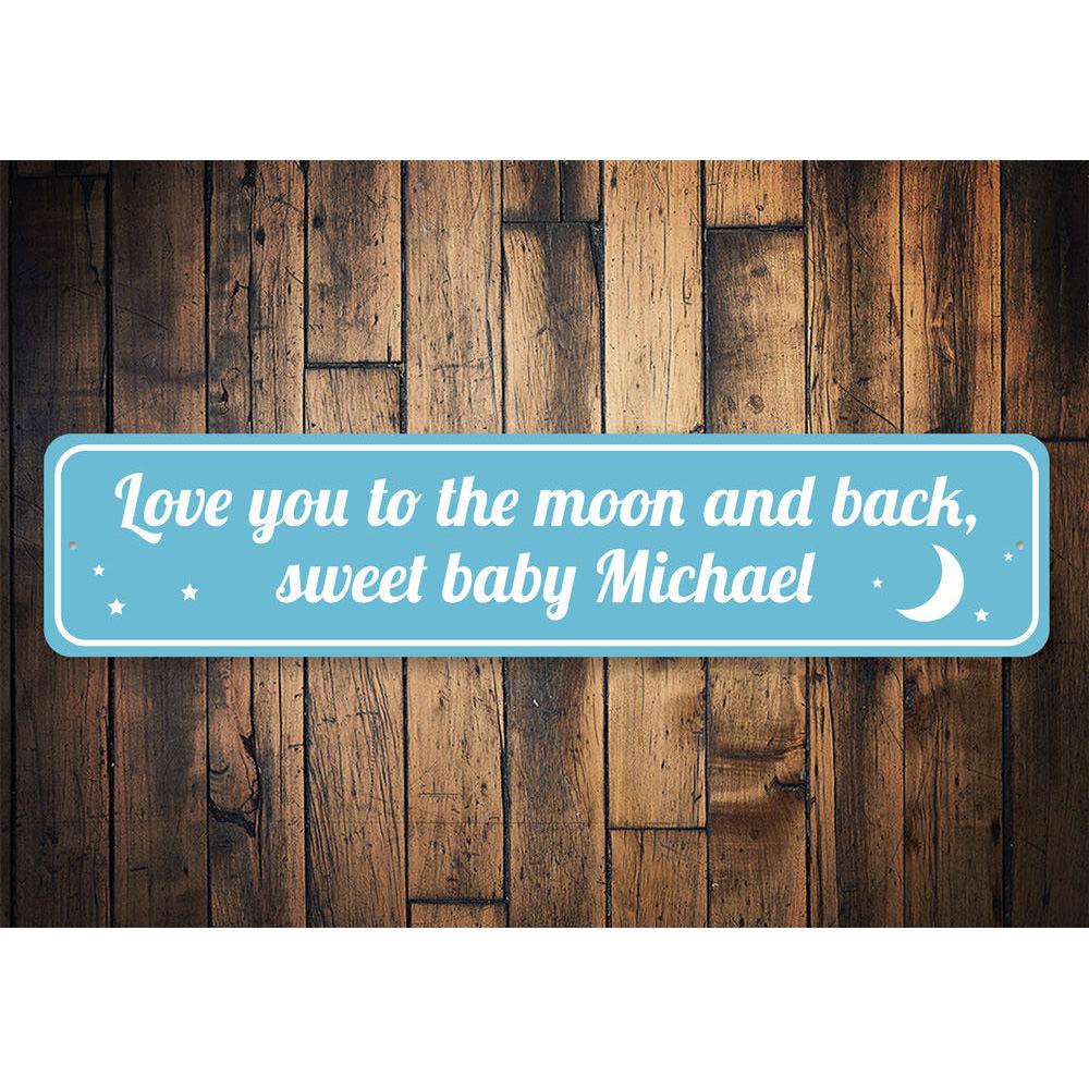 Decorative 'Love You To The Moon and Back' sign made of aluminum, featuring a whimsical design perfect for children's rooms.