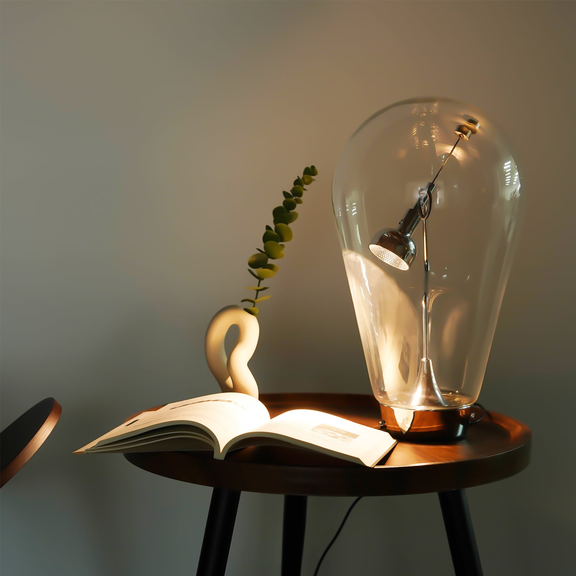 Magnetic Dimmable Table Lamp featuring a clear glass shade and nickel-plated base, showcasing its modern geometric design.