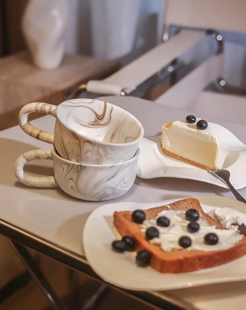 Stylish marbleized ceramic mug with elegant design, perfect for coffee or tea.