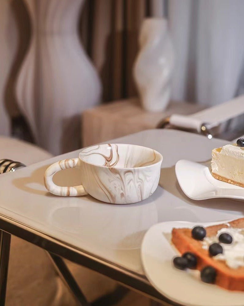 Stylish marbleized ceramic mug with elegant design, perfect for coffee or tea.