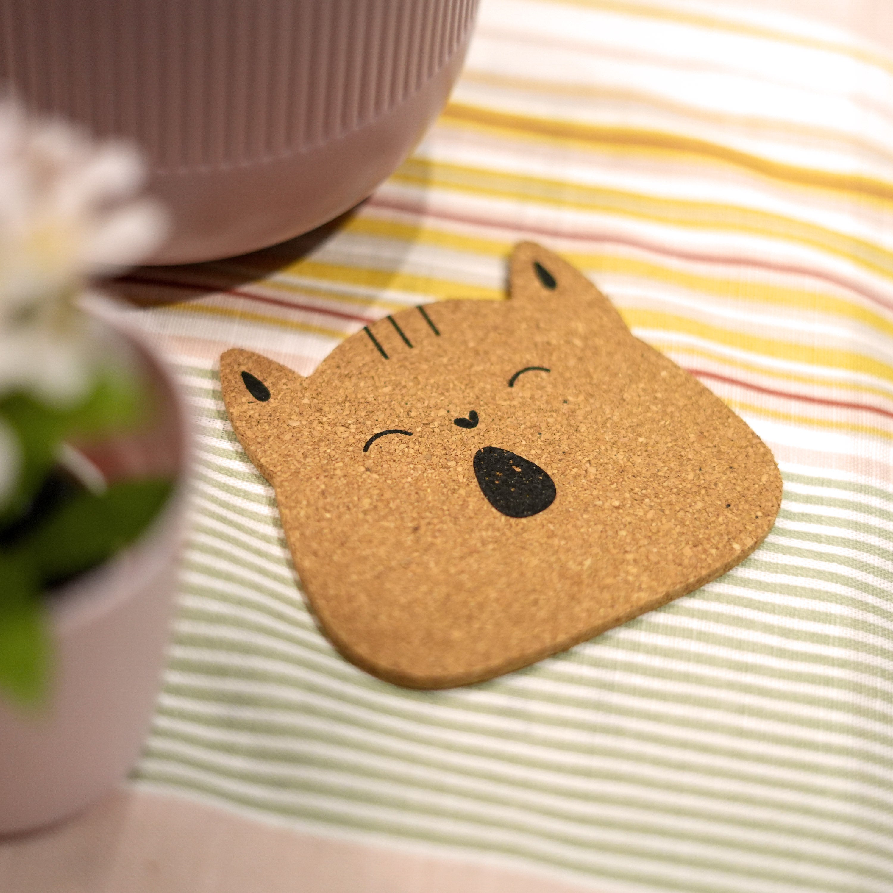 Set of 6 round cork coasters featuring different cute cat faces, perfect for protecting furniture and showcasing love for cats.