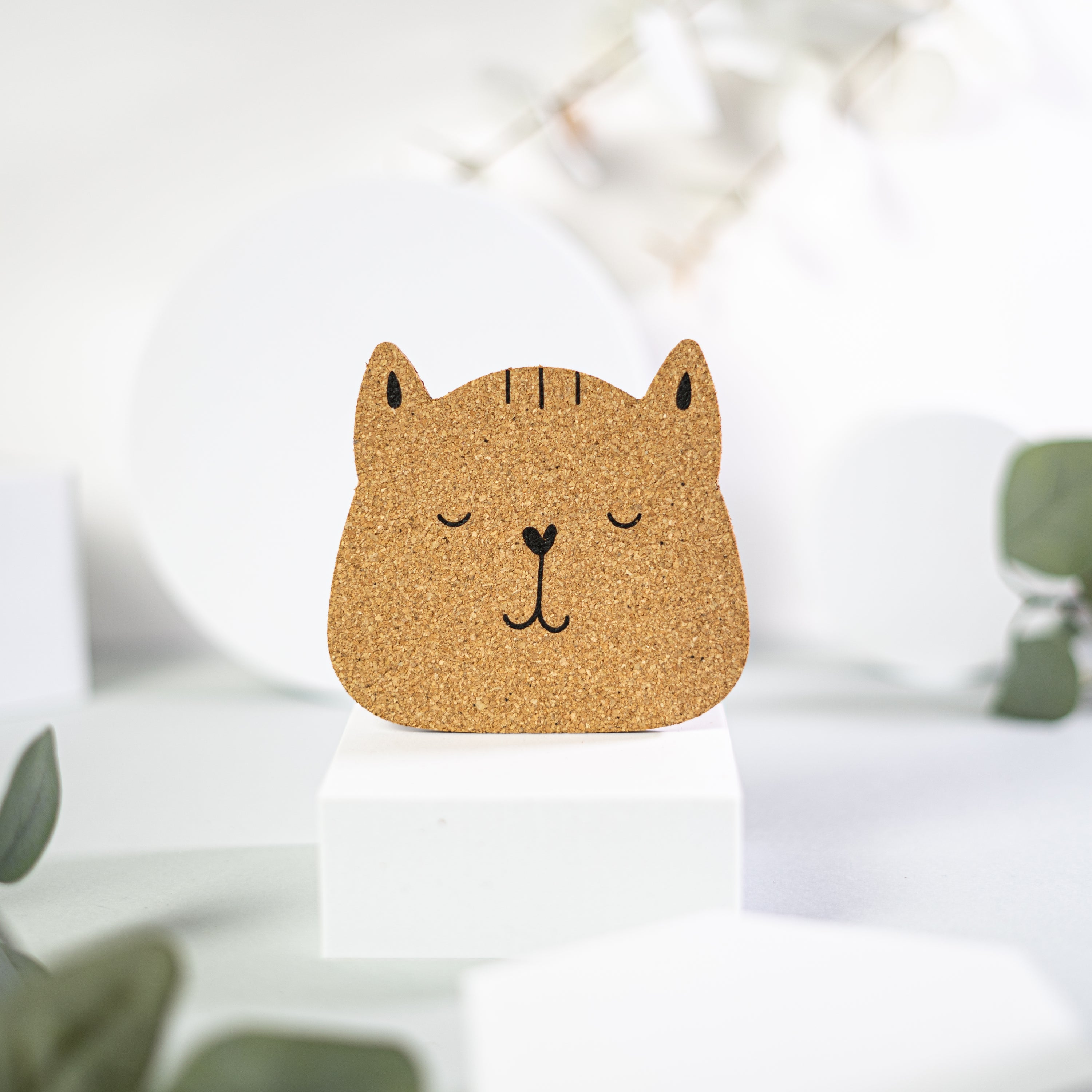 Set of 6 round cork coasters featuring different cute cat faces, perfect for protecting furniture and showcasing love for cats.