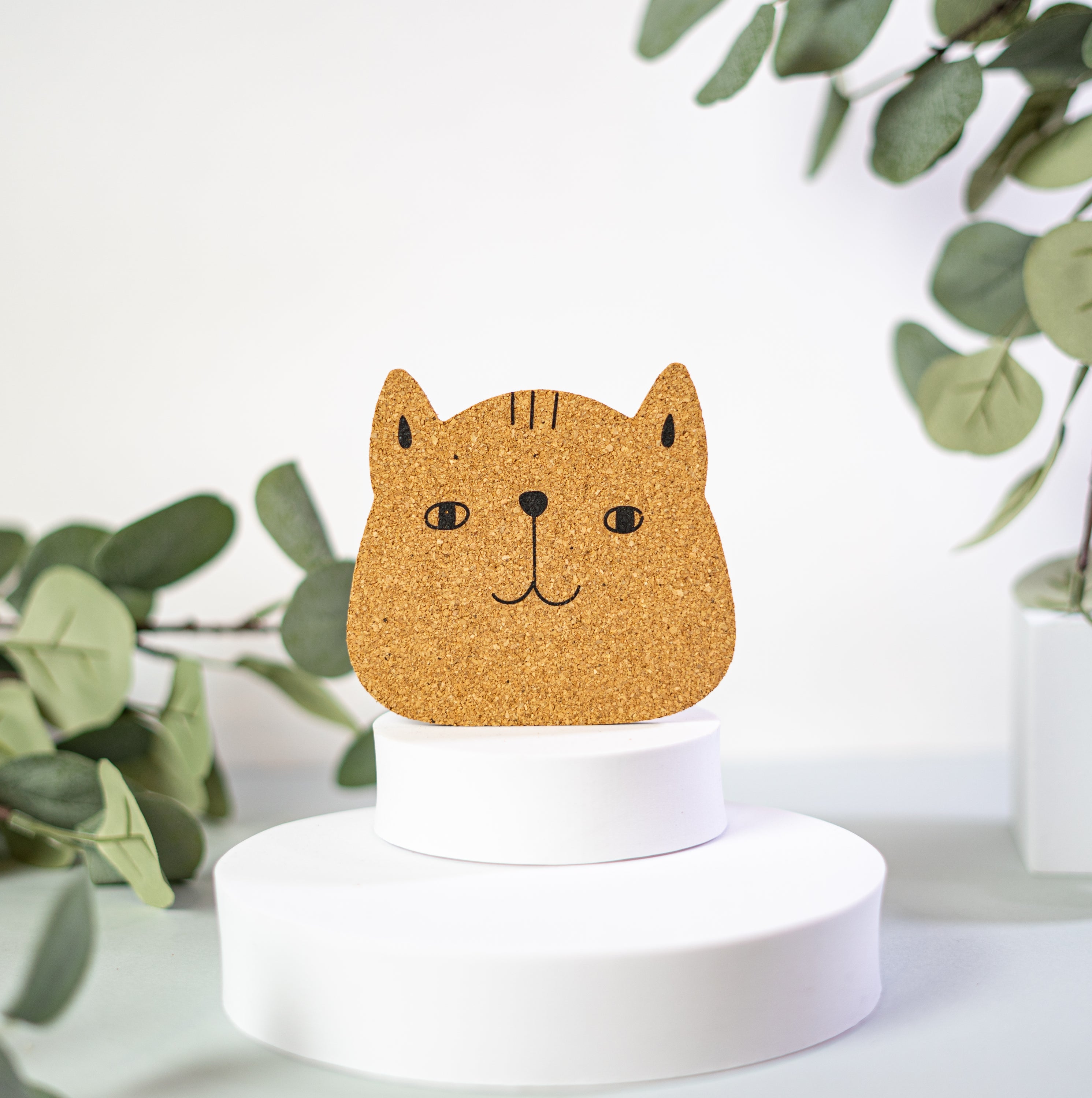 Set of 6 round cork coasters featuring different cute cat faces, perfect for protecting furniture and showcasing love for cats.