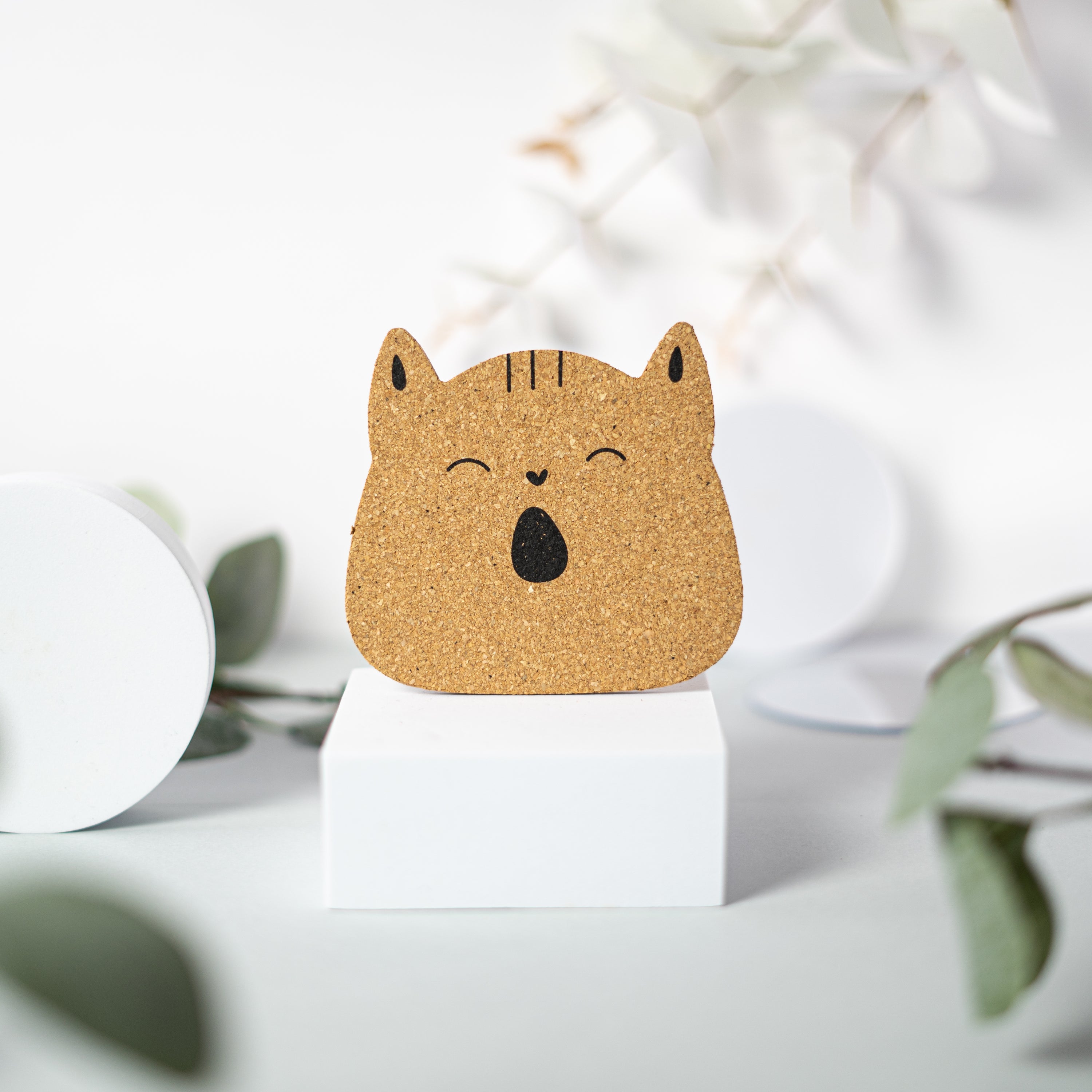 Set of 6 round cork coasters featuring different cute cat faces, perfect for protecting furniture and showcasing love for cats.