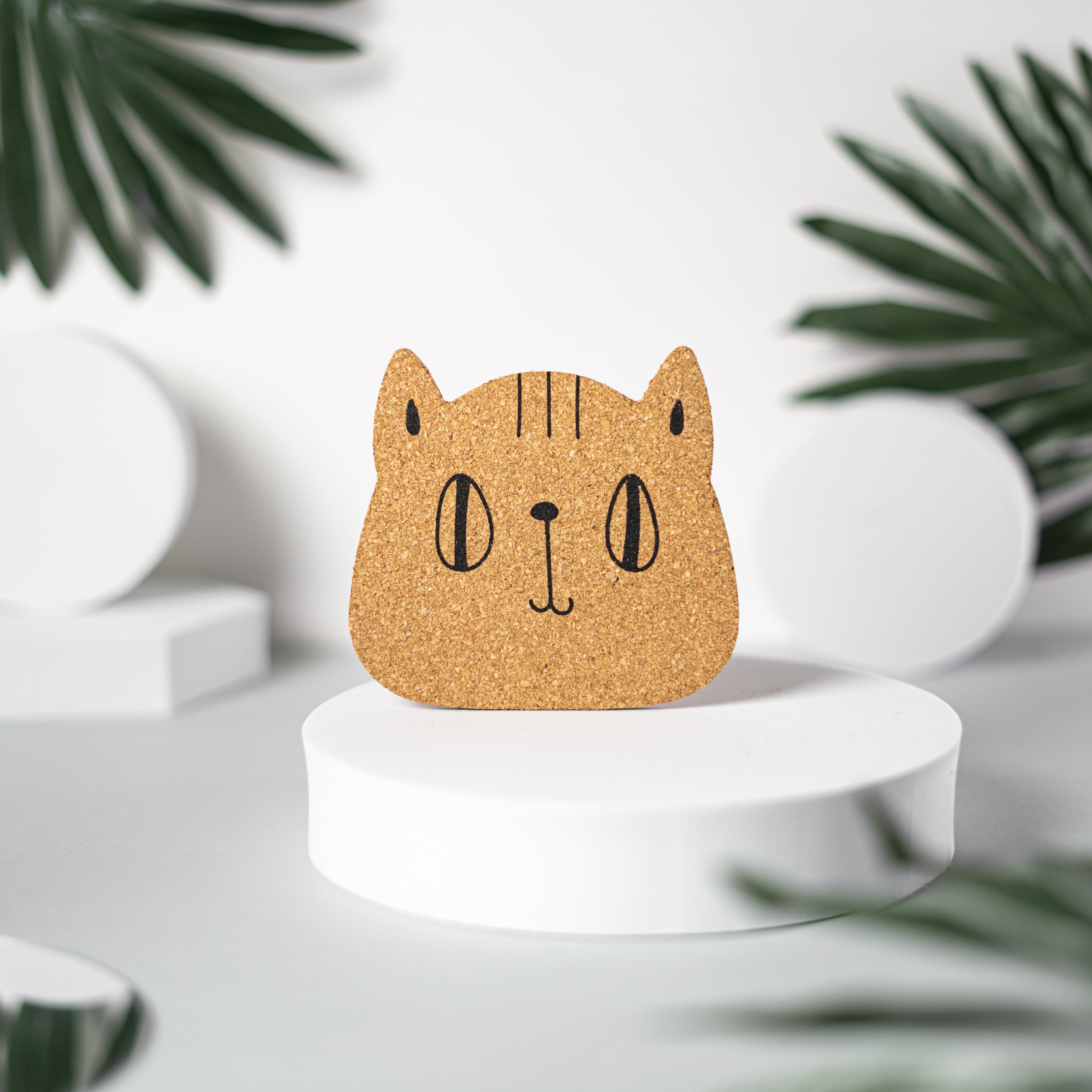 Set of 6 round cork coasters featuring different cute cat faces, perfect for protecting furniture and showcasing love for cats.