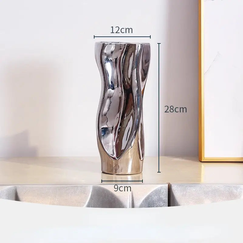 A unique black melted molten ceramic vase with organic textures and irregular shapes, showcasing its handcrafted artistry.