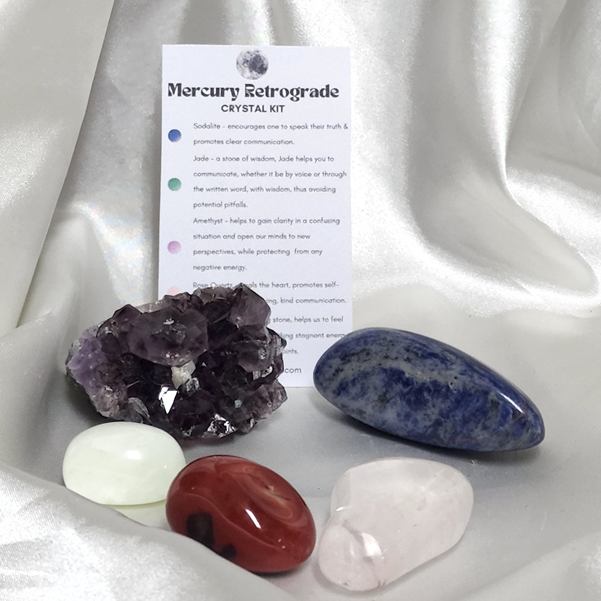 Mercury Retrograde Crystal Kit featuring Jade, Amethyst, Rose Quartz, Red Jasper, and Sodalite in a decorative arrangement.