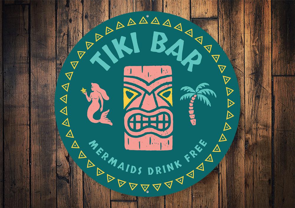 Mermaids Drink Free Tiki Bar Sign made of aluminum, featuring vibrant colors and whimsical design, perfect for home bars and outdoor spaces.