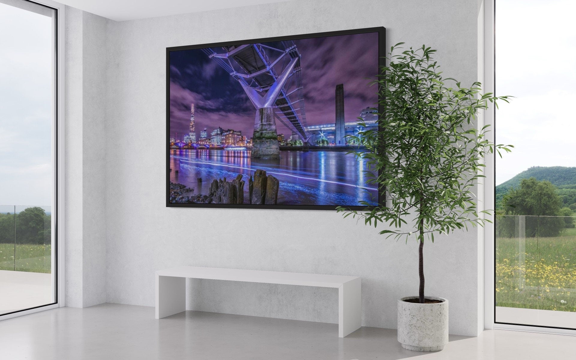 A stunning night view of the Millennium Bridge illuminated against the dark sky, showcasing its architectural beauty over the River Thames.