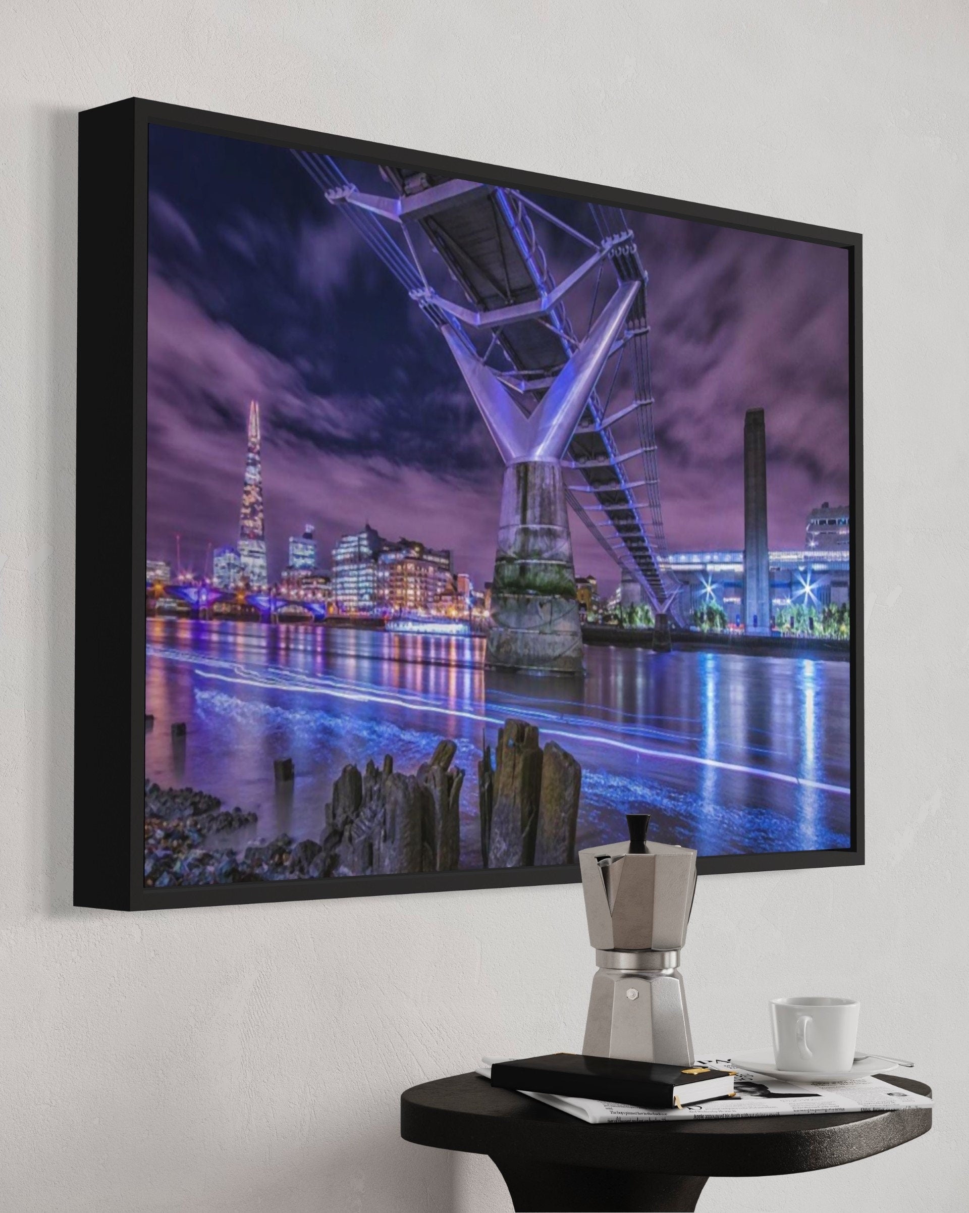 A stunning night view of the Millennium Bridge illuminated against the dark sky, showcasing its architectural beauty over the River Thames.