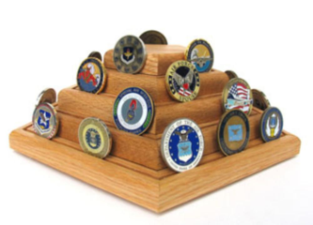 A beautifully crafted Military Challenge Coin Display made of solid oak, featuring a pyramid design with multiple grooved rows for showcasing challenge coins.