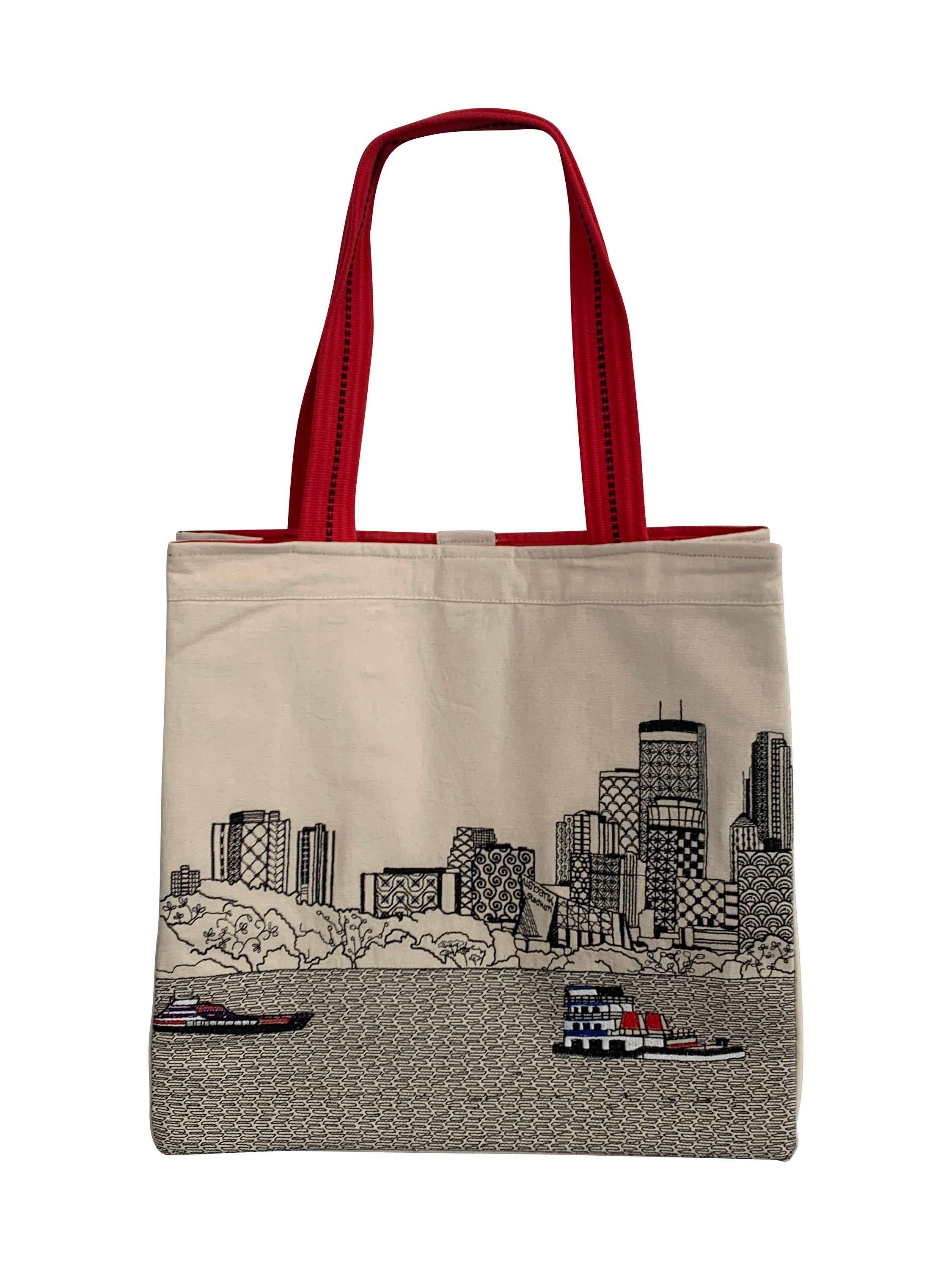 Minneapolis Tote Bag featuring embroidered skyline design on cream and black cotton canvas with red waterproof lining and ribbed straps.