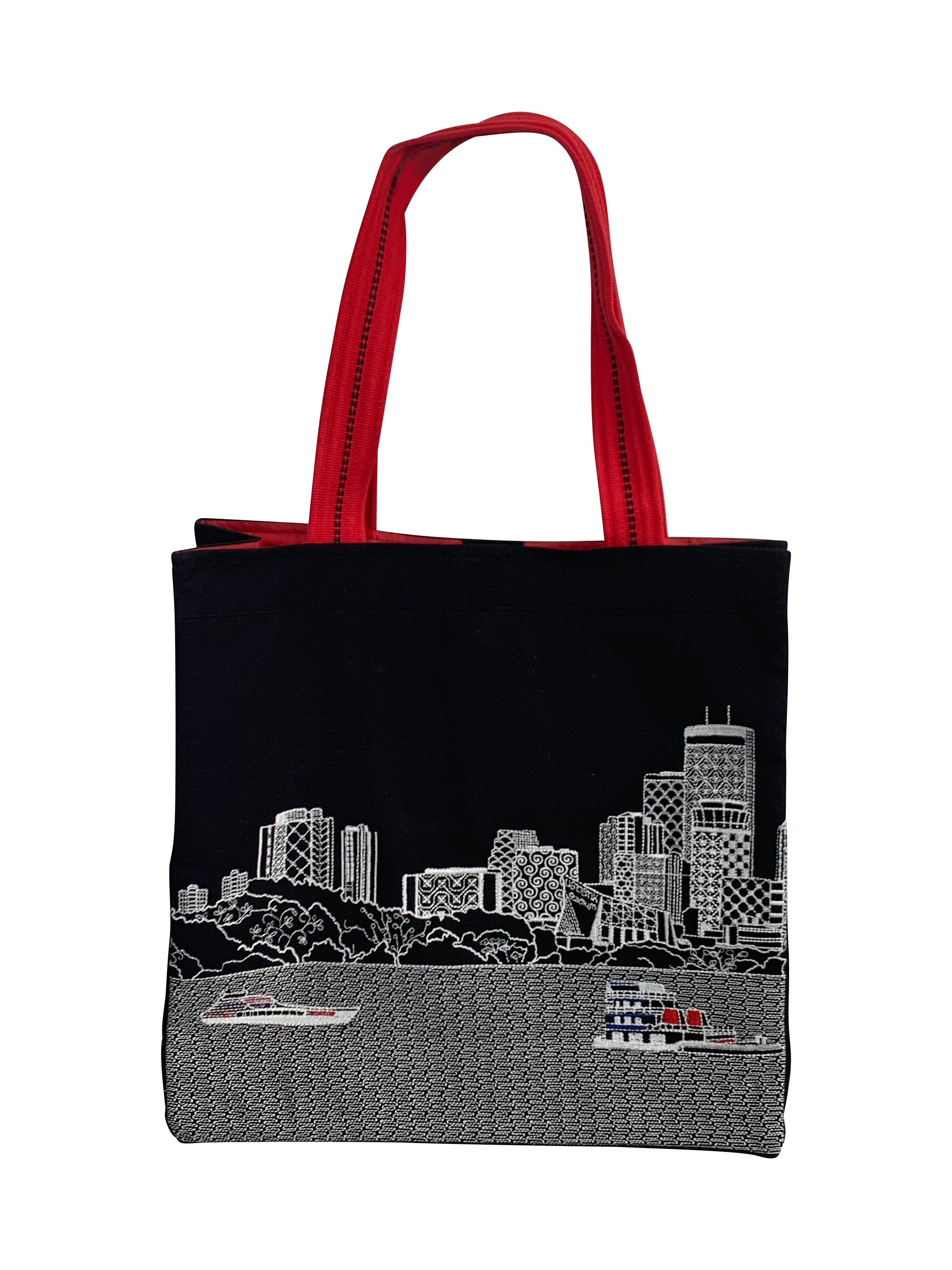 Minneapolis Tote Bag featuring embroidered skyline design on cream and black cotton canvas with red waterproof lining and ribbed straps.