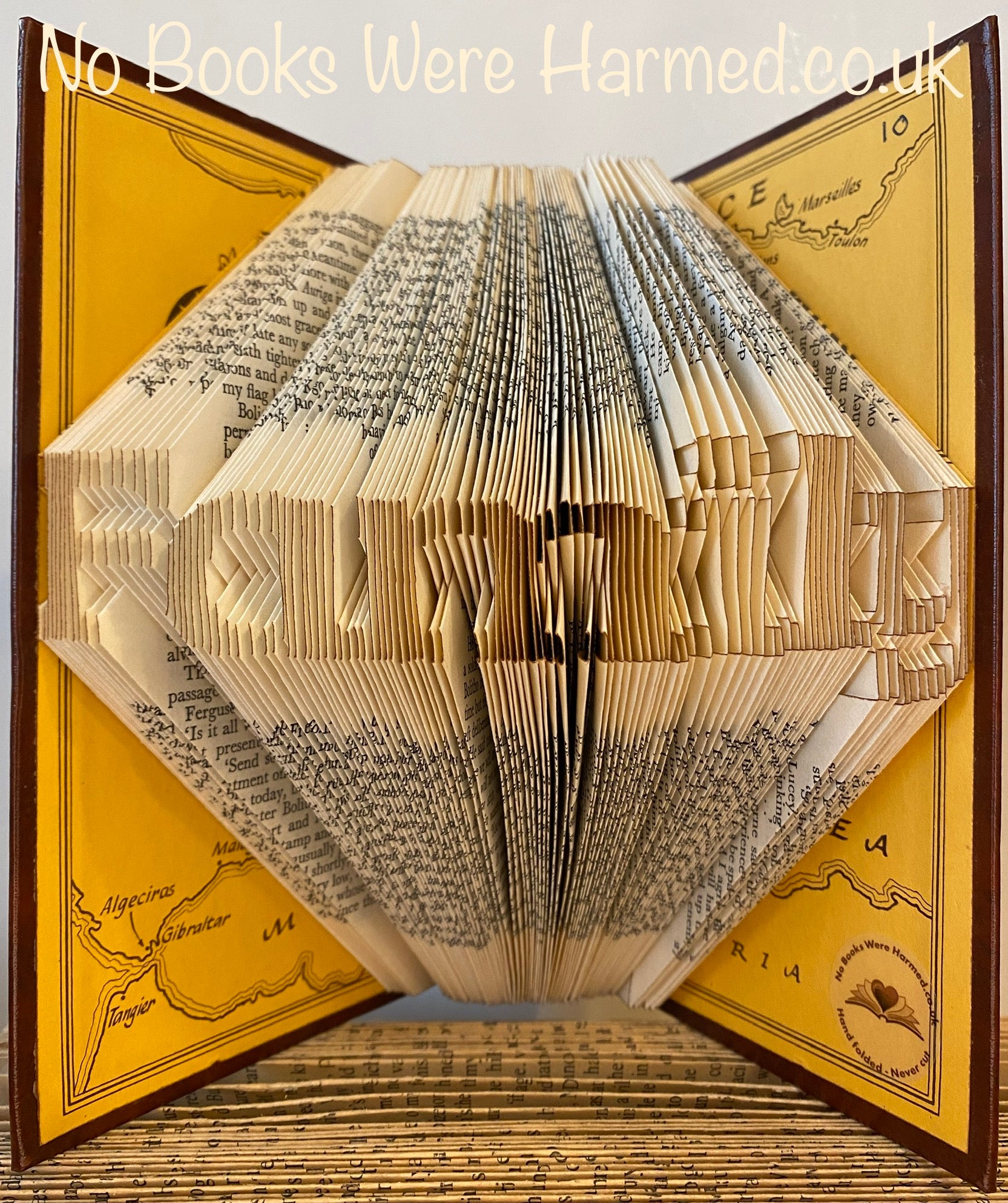 Mini 'Family' art piece handcrafted from vintage books, showcasing unique hand-folded pages in a charming design.