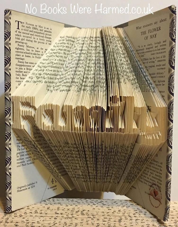 Mini 'Family' art piece handcrafted from vintage books, showcasing unique hand-folded pages in a charming design.