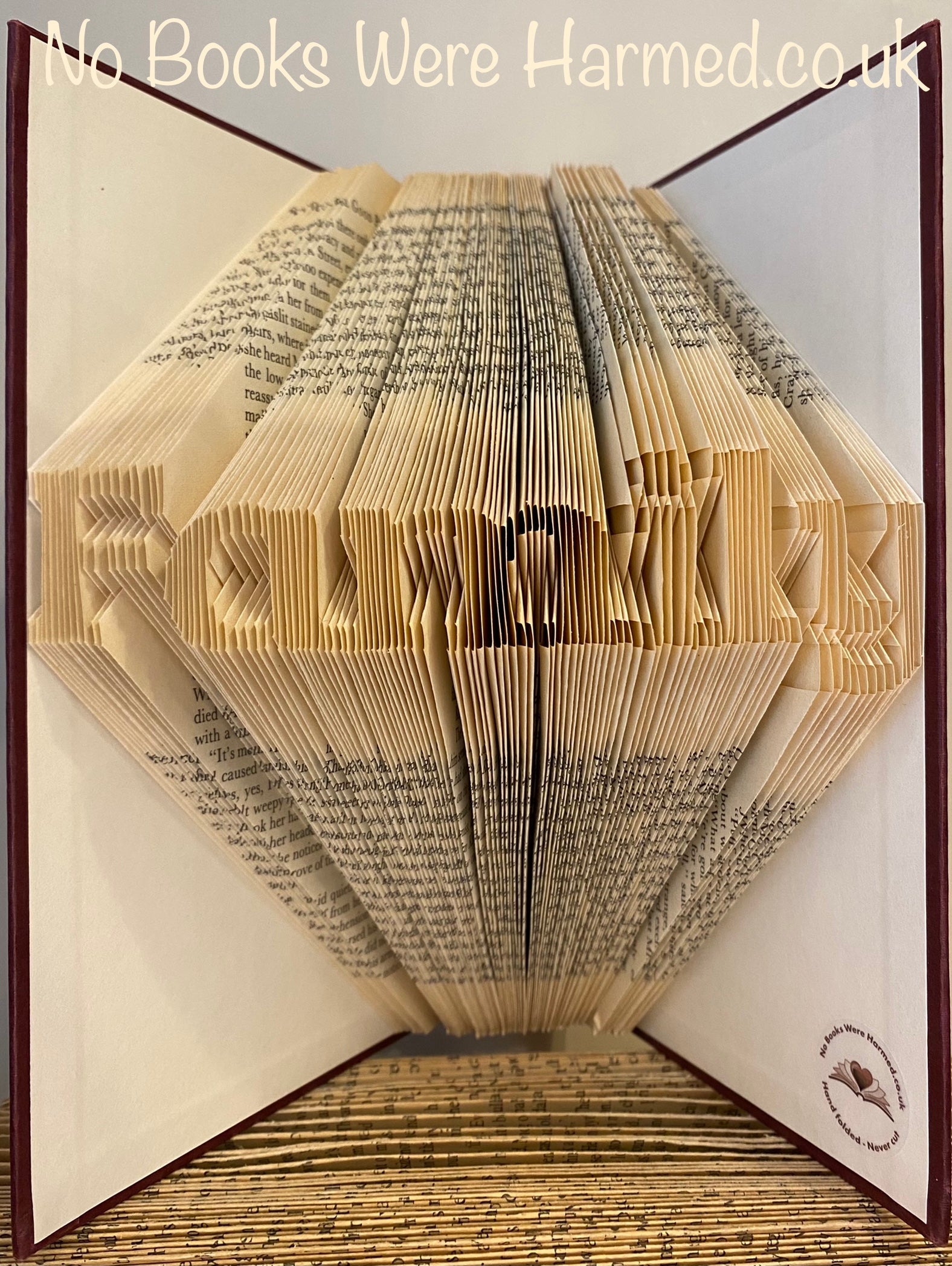 Mini 'Family' art piece handcrafted from vintage books, showcasing unique hand-folded pages in a charming design.