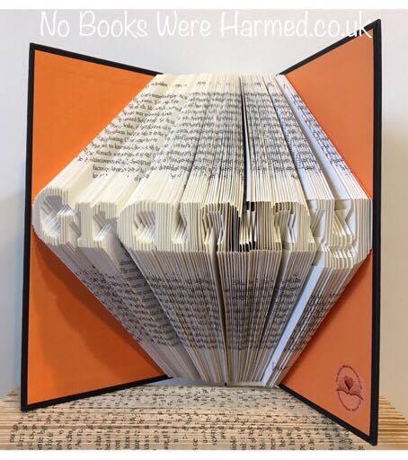 Mini 'Granny' art piece handcrafted from vintage books, showcasing intricate hand-folded pages in a unique design.