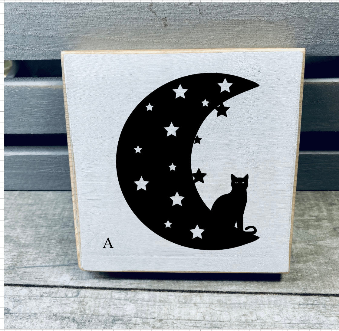 A set of hand-painted Mini Moon Shelf Sitters featuring unique moon designs in black on a white background, made from solid pine.