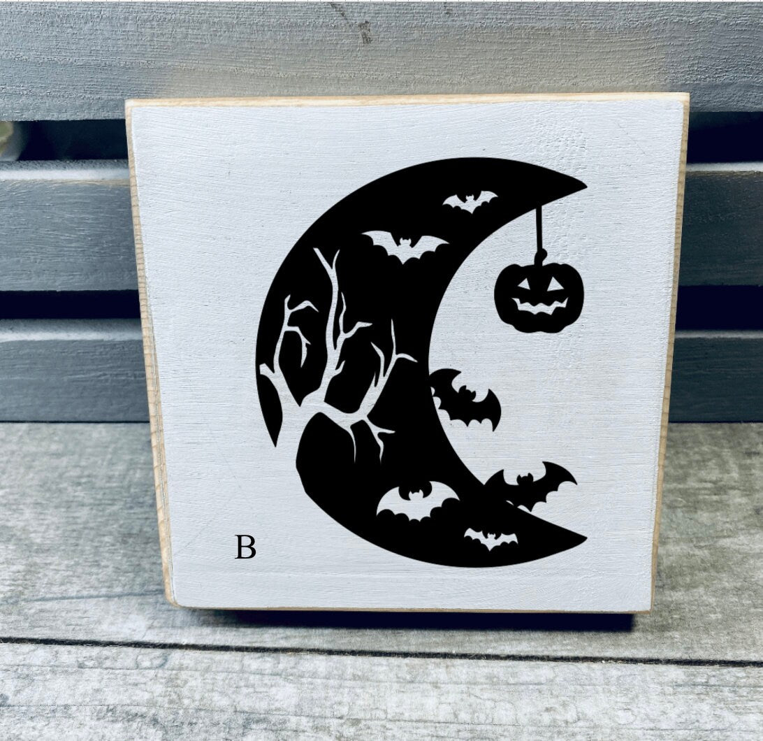 A set of hand-painted Mini Moon Shelf Sitters featuring unique moon designs in black on a white background, made from solid pine.