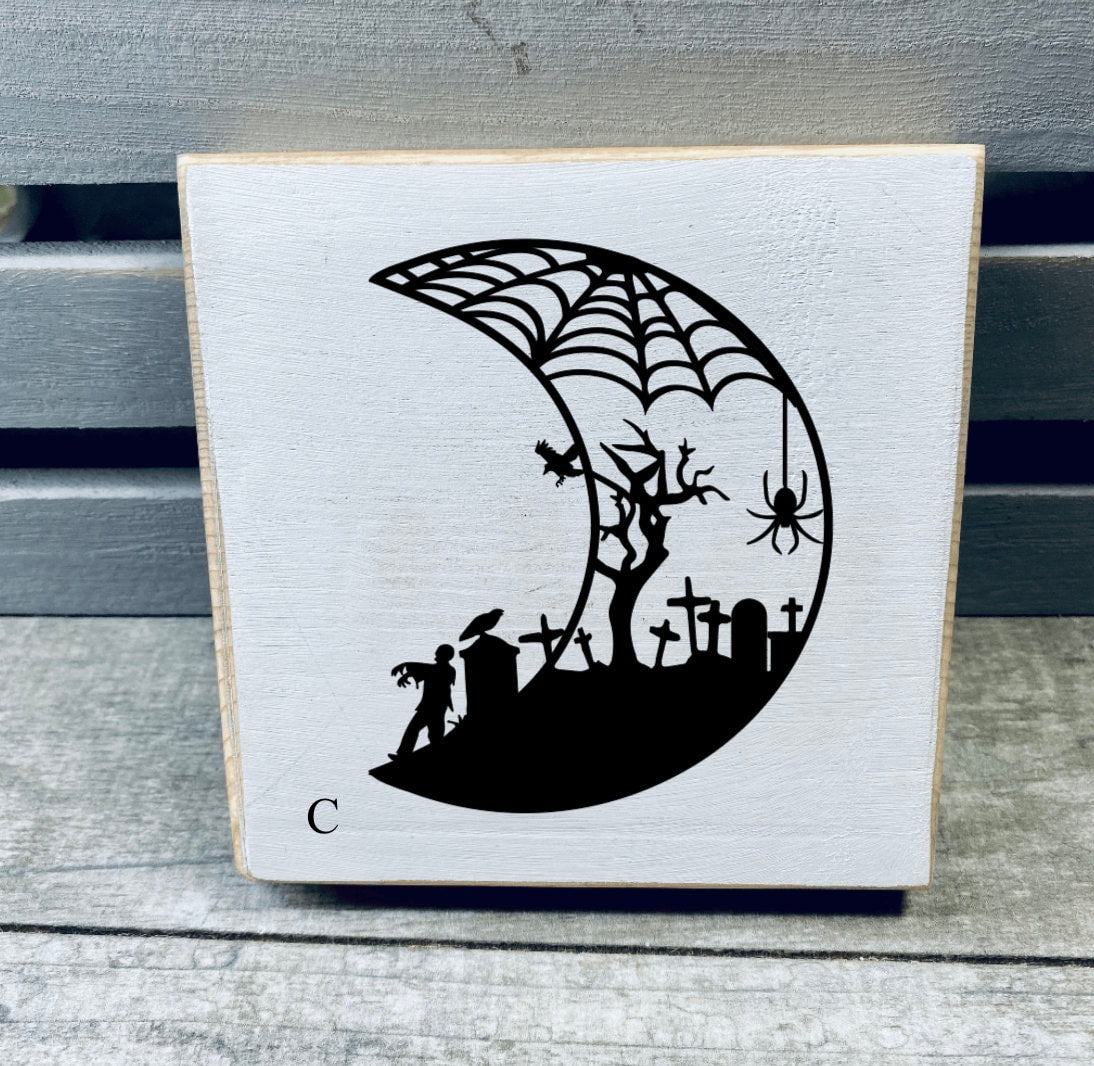 A set of hand-painted Mini Moon Shelf Sitters featuring unique moon designs in black on a white background, made from solid pine.