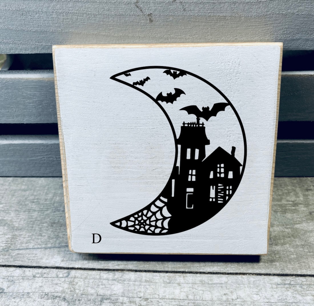 A set of hand-painted Mini Moon Shelf Sitters featuring unique moon designs in black on a white background, made from solid pine.