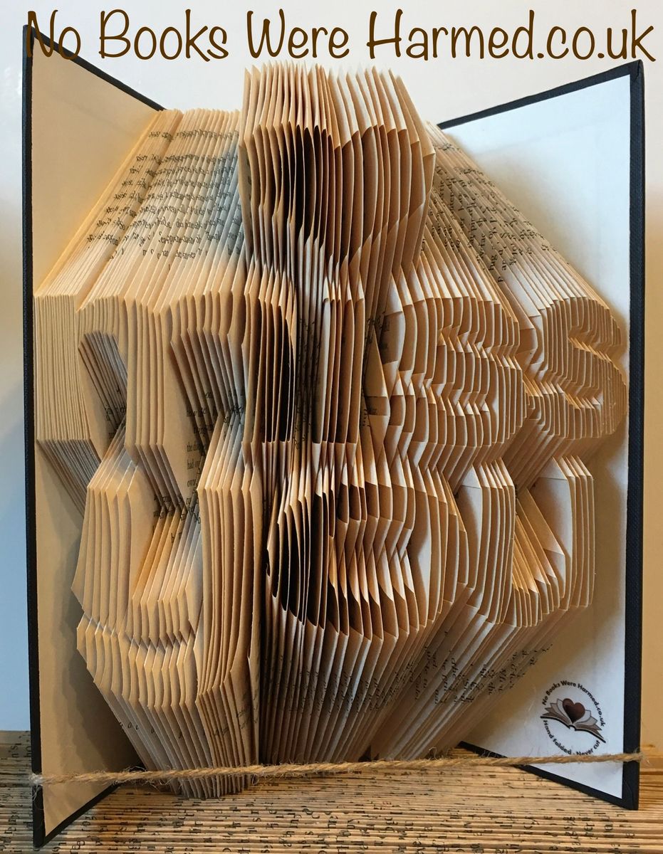 A unique hand-folded book art piece titled 'Miss You', crafted from vintage books, showcasing intricate designs and textures.